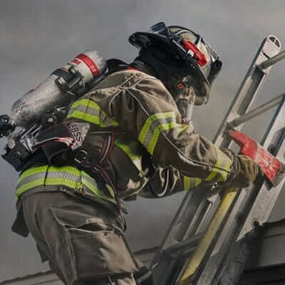 Firefighter climbing a ladder